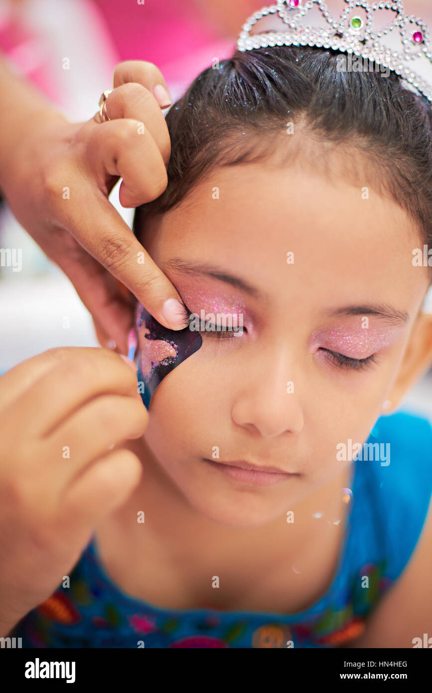 draw make up butterfly on little girl face Stock Photo