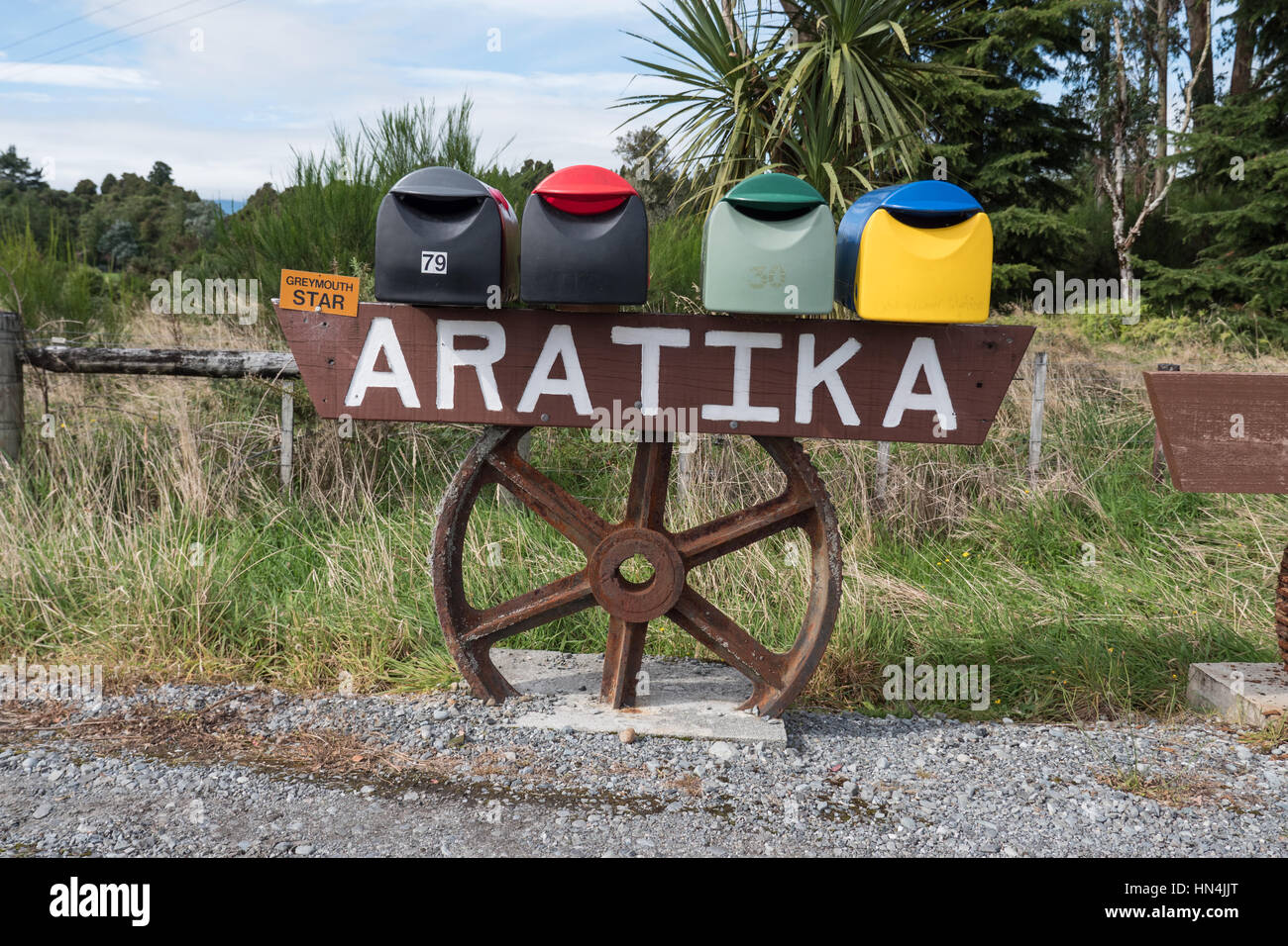 Mail boxes mounted on wheel and frame on the roadside. New Zealand ...