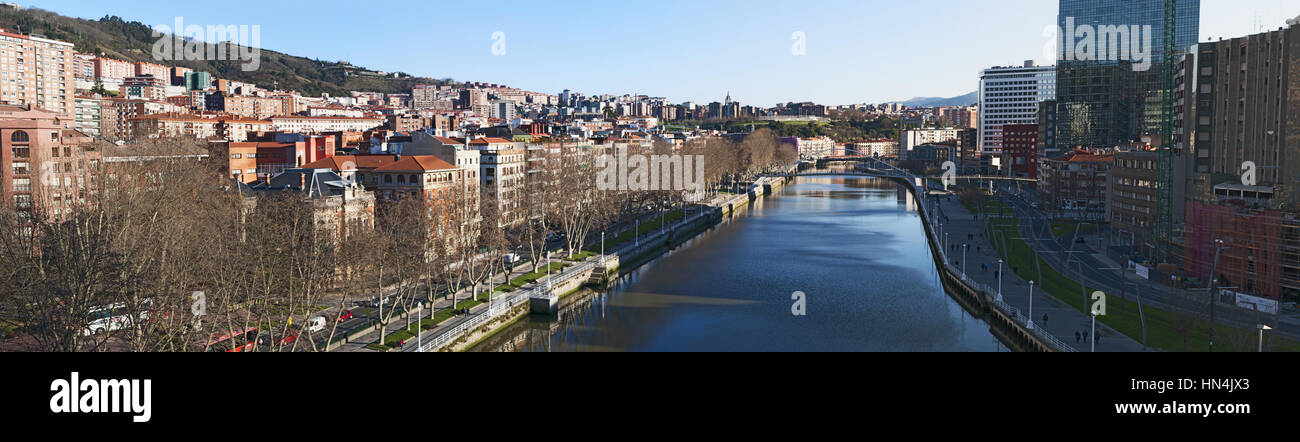Spain: skyline of Bilbao and Nervion River with view of the Zubizuri, the white bridge or the Campo Volantin Bridge by Santiago Calatrava Stock Photo