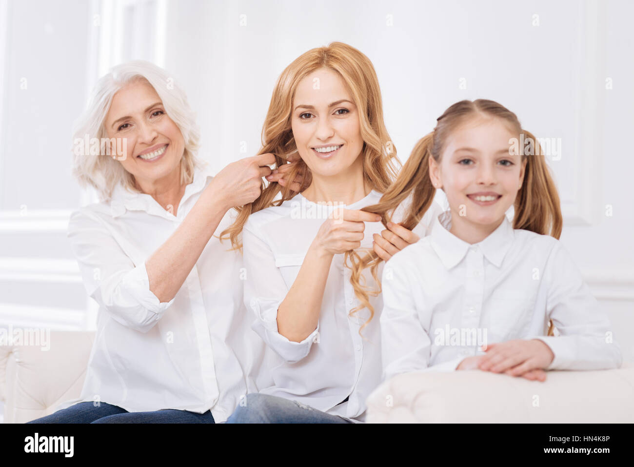 Family members making hair styles for each other Stock Photo - Alamy