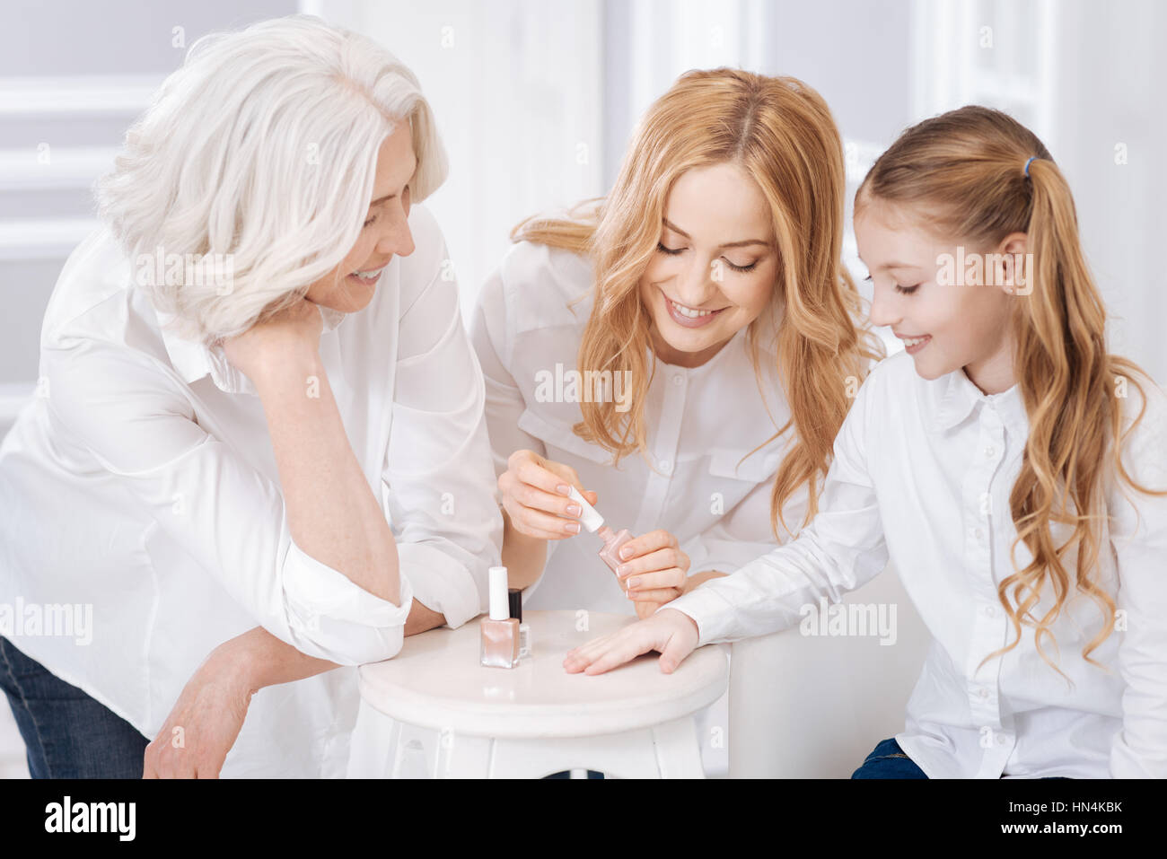 Pleasat mother painting nails of her daughter Stock Photo Alamy