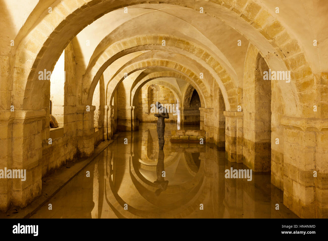 Winchester, Hampshire, UK - May 15, 2014: The flooded Crypt of Winchester Cathedral containing the sculpture 'Sound II' by british artist Antony Gorml Stock Photo