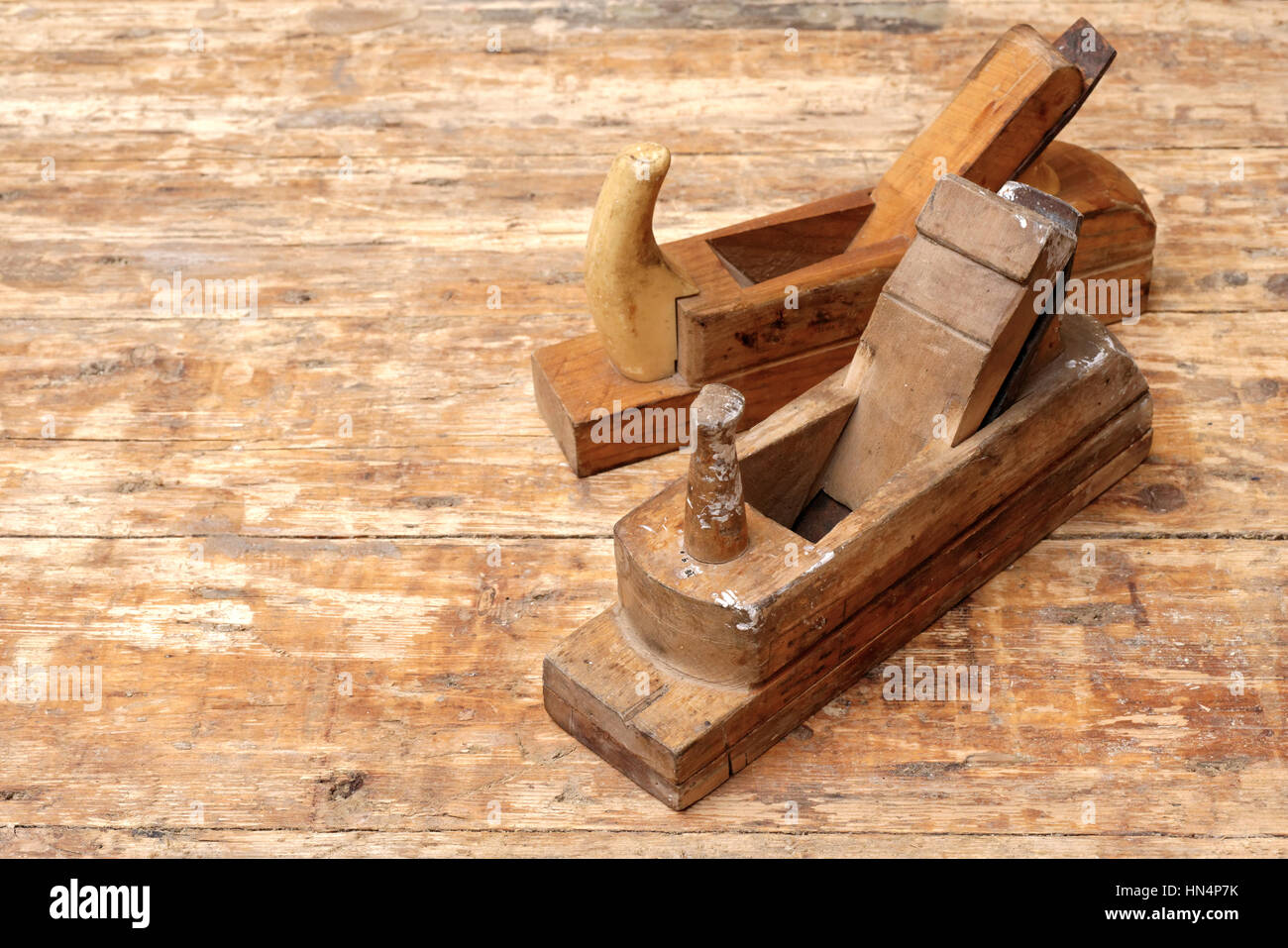 Backgrounds and textures: two old carpenter's planes on a wooden workbench Stock Photo