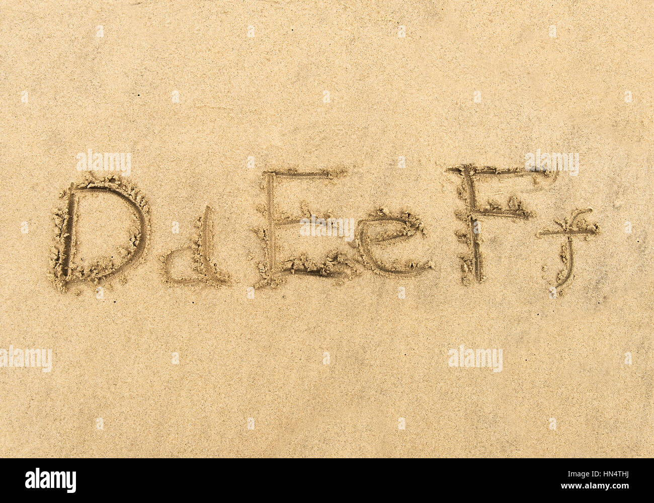 alphabet letters handwritten in sand on beach Stock Photo - Alamy