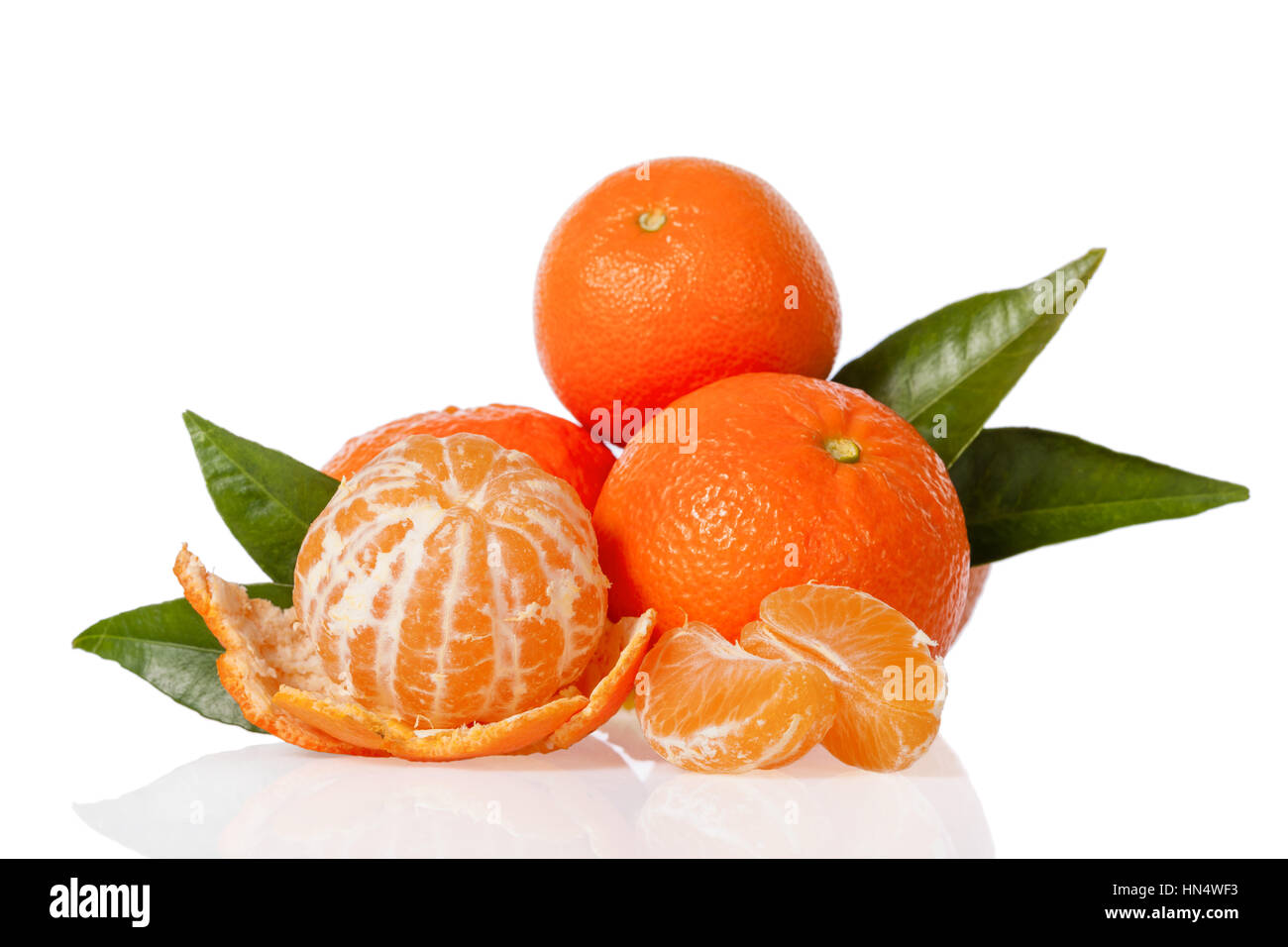 Clementines with a peeled clementine isolated on white background Stock