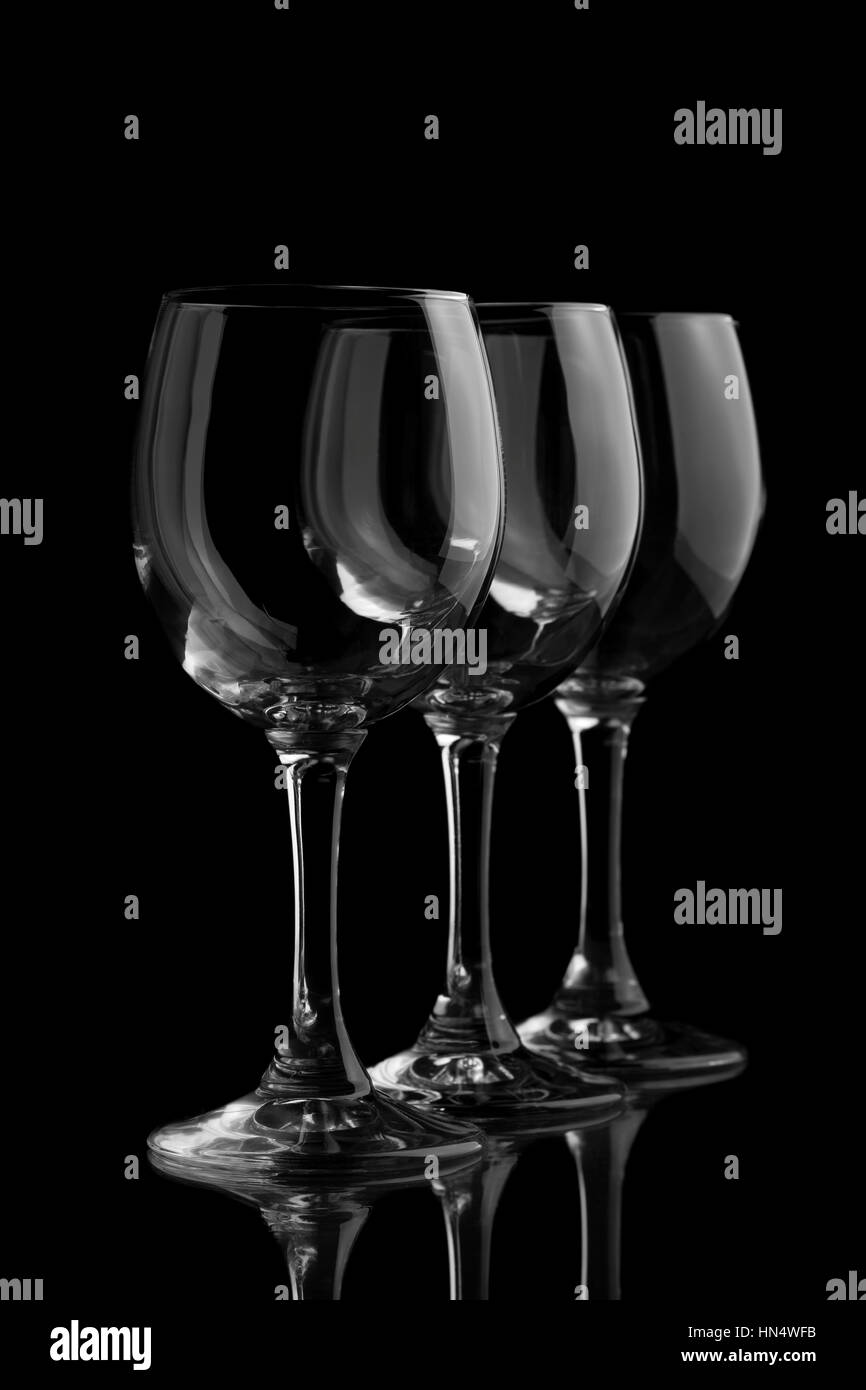 Three elegant wine glasses in a black background Stock Photo