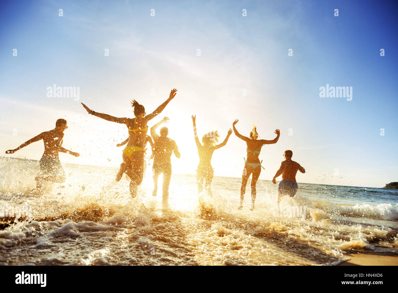 Crowd people friends sunset beach holidays Stock Photo