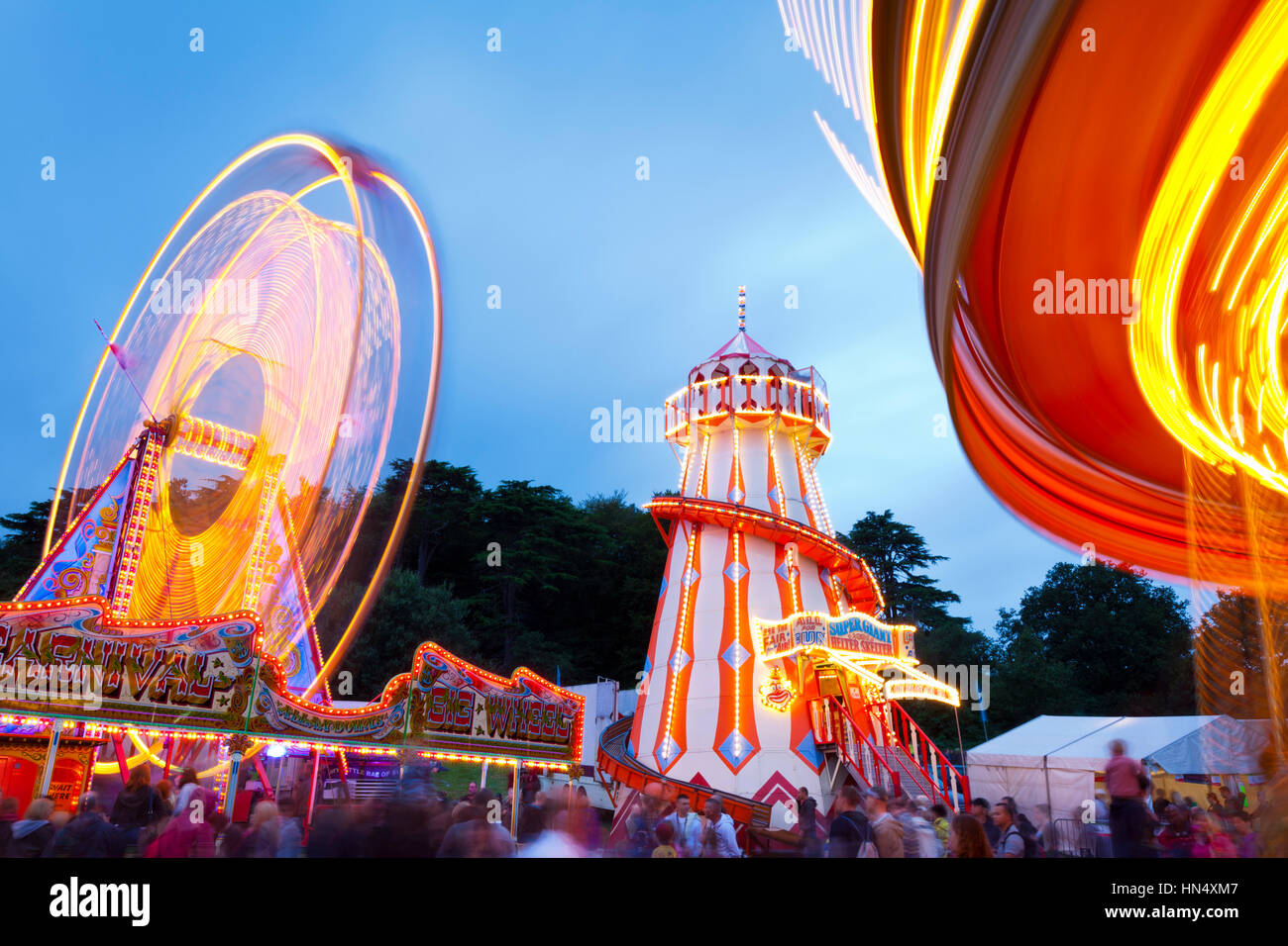 Bristol, United Kingdom - August 13, 2011: Evening Funfair rides within the grounds of Ashton Court during the Bristol Balloon Fiesta in 2011. The peo Stock Photo