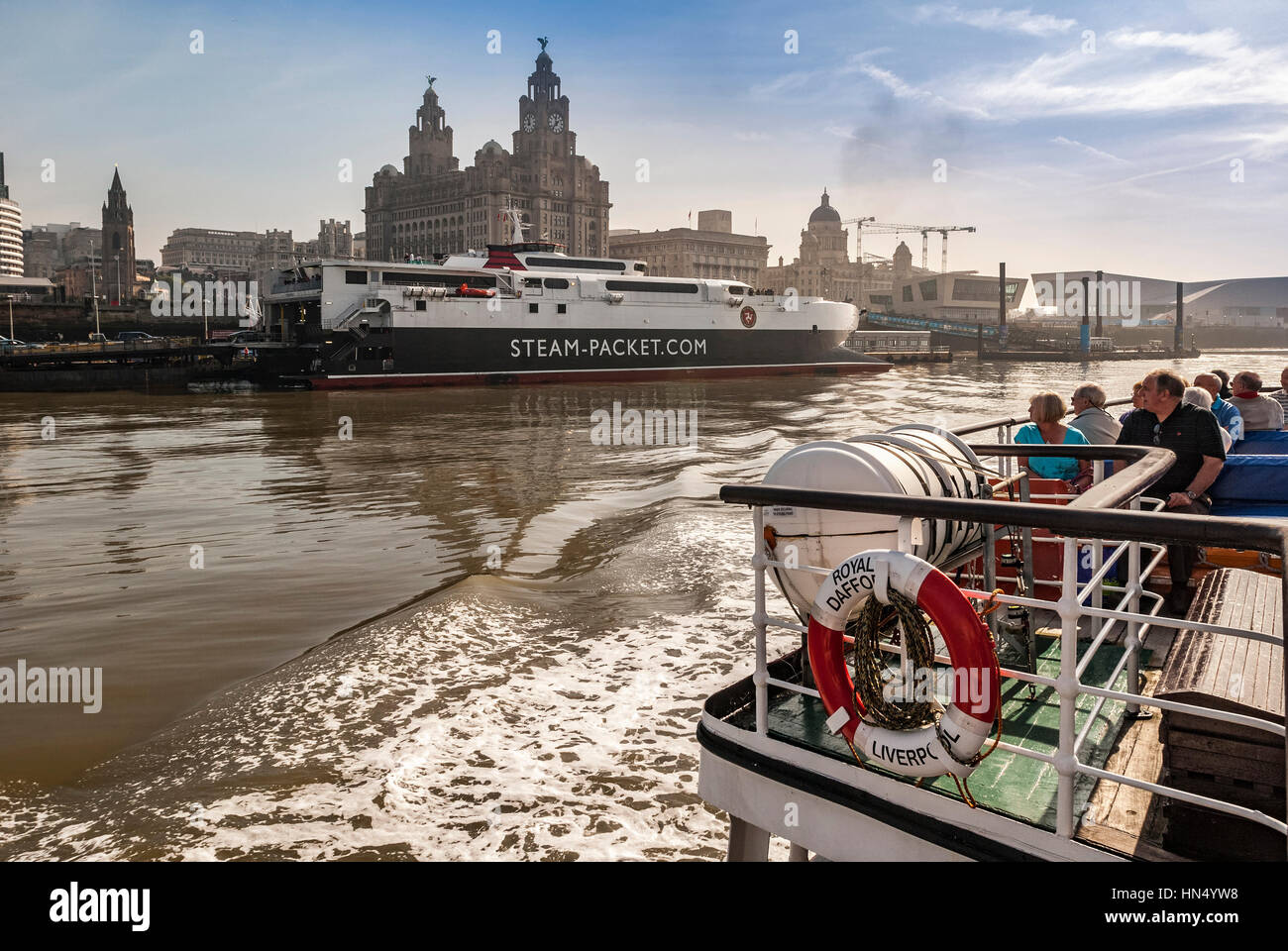 Liverpool pierhead with the Royal Liver building and the Isle of Mann ferry Manannan seen from the Mersey Ferry. Stock Photo