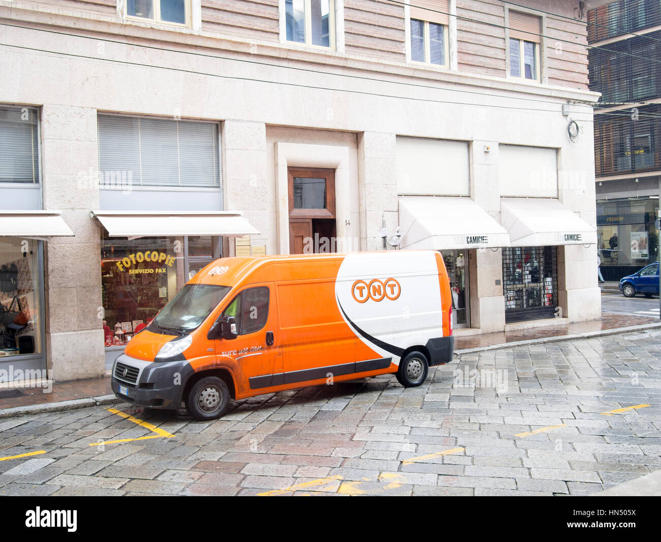 TNT courier van on a winter rainy day in the city center. Italy Stock Photo