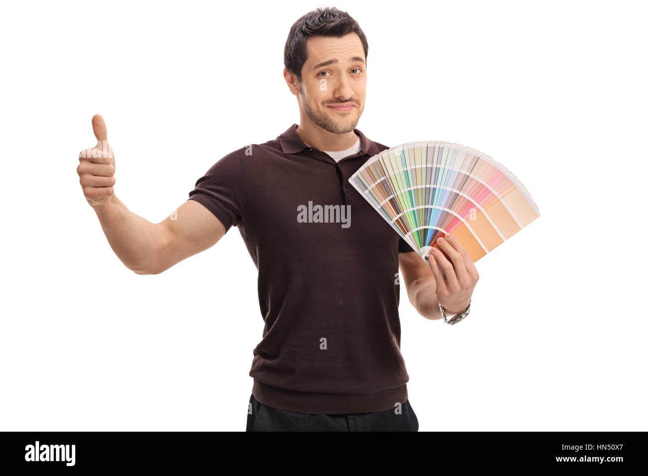 Man holding a color swatch and making a thumb up sign isolated on white background Stock Photo