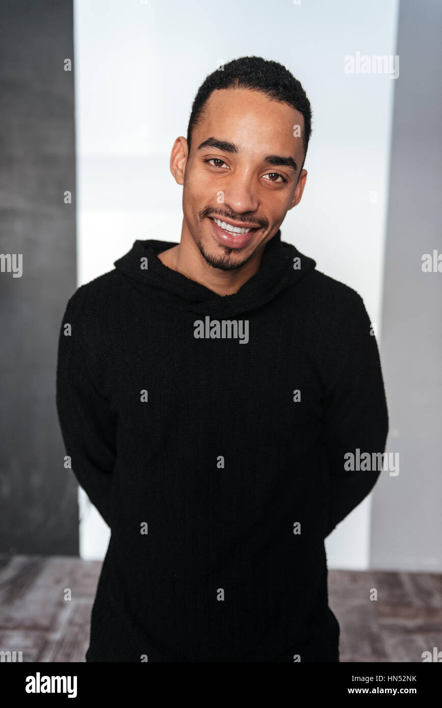 Portrait of smiling african american young man in black hoodie over ...