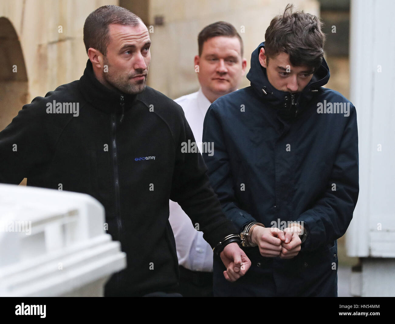 Michael March (right) is escorted in handcuffs from Newcastle Crown ...