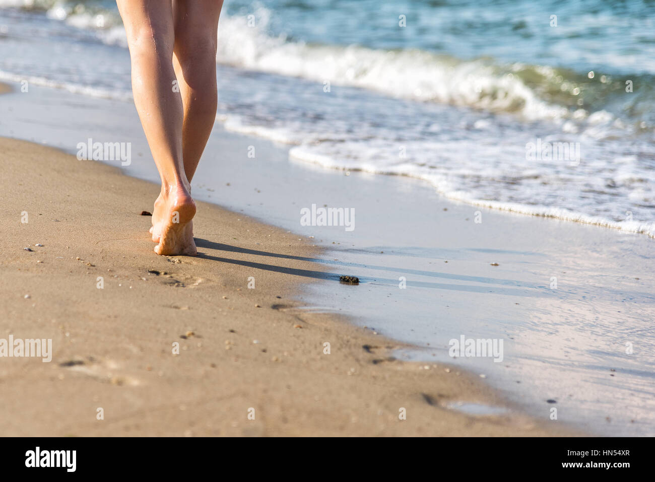 Woman walking barefoot beach hi-res stock photography and images - Alamy