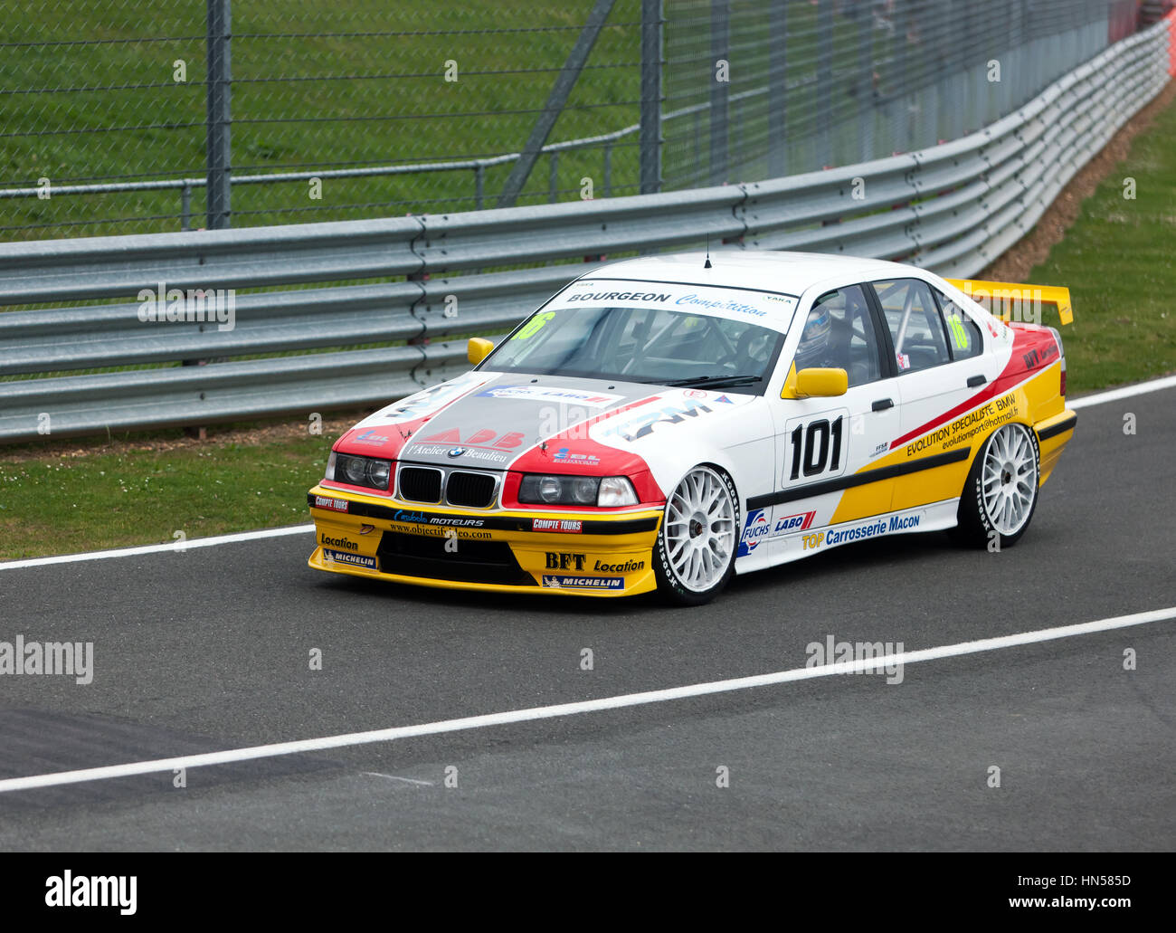 A 1997, BMW 320i, driven by Don Grice, enters the international pit lane during the Jet Super Touring Car Trophy, at the 2016 Silverstone Classic Stock Photo