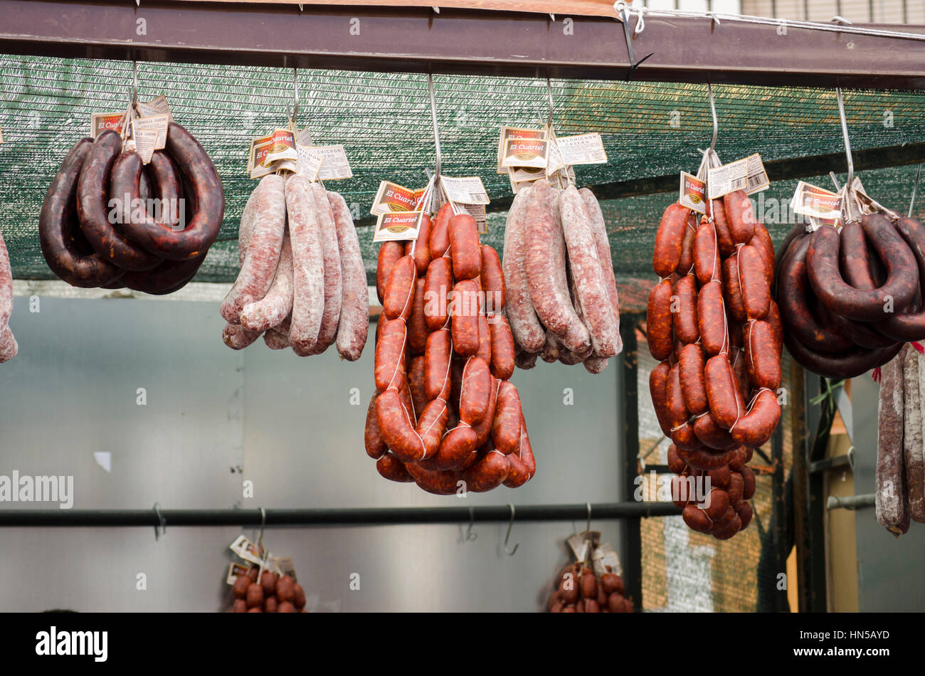 Salchichon, Chorizo and Morcilla sausages hanging at spanish market