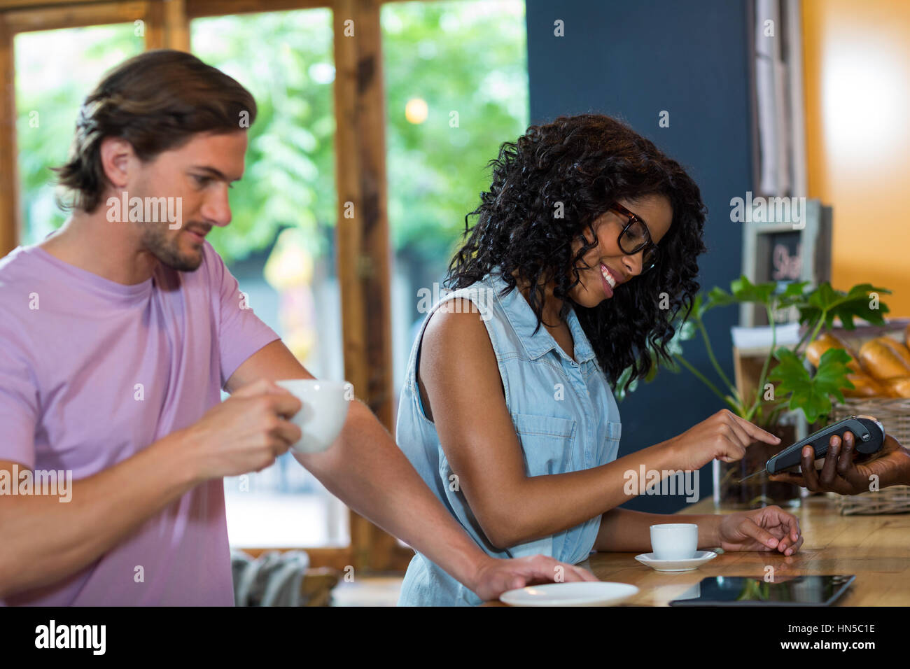 Woman entering restaurant hi-res stock photography and images - Alamy
