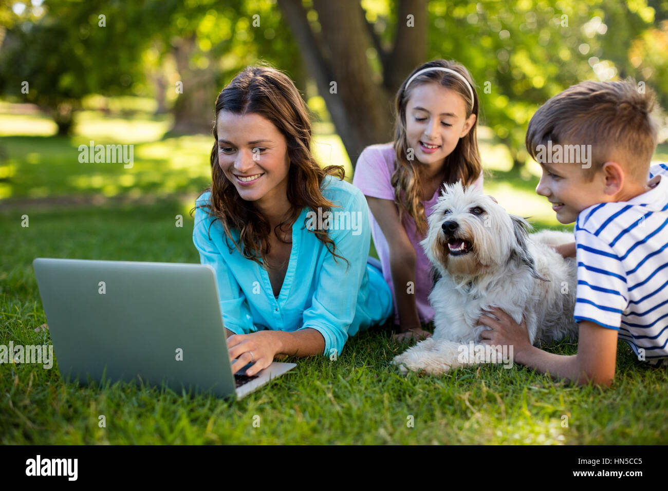 Happy family enjoying in park on sunny a day Stock Photo - Alamy