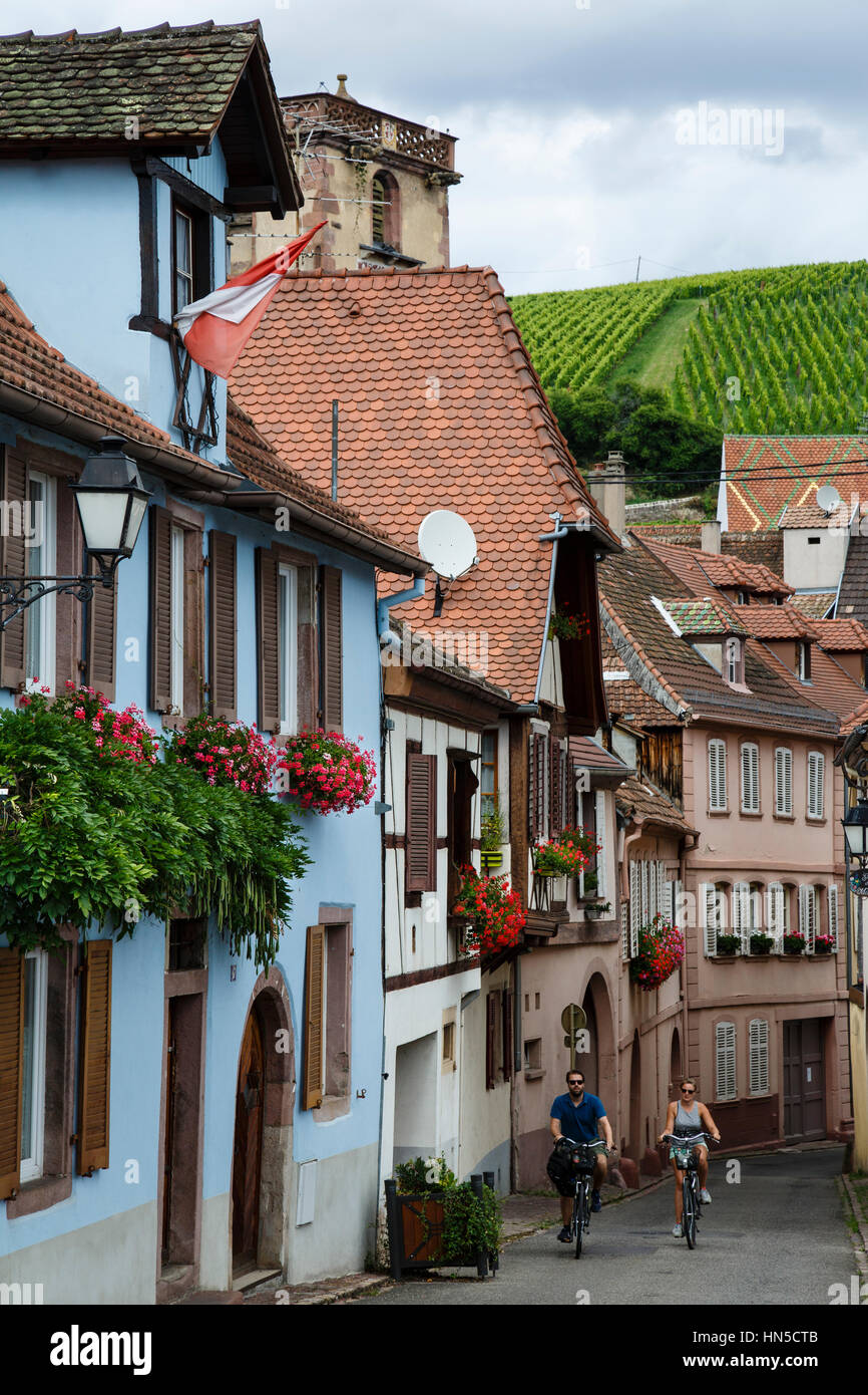 Couple cycling in Ribeauvillé, Alsace, France Stock Photo