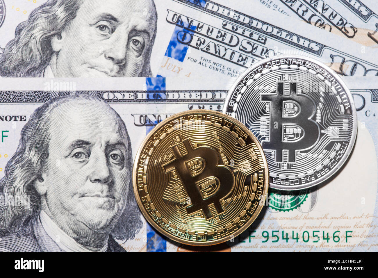 Two Bitcoins on hundred dollars bills. Closeup, macro shot Stock Photo ...