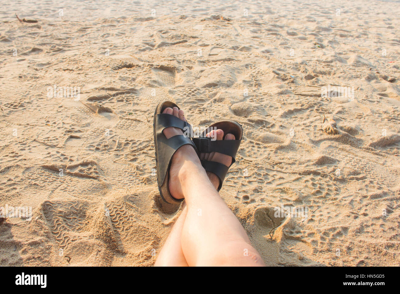 Summer and beach concept - human feet on the beach Stock Photo