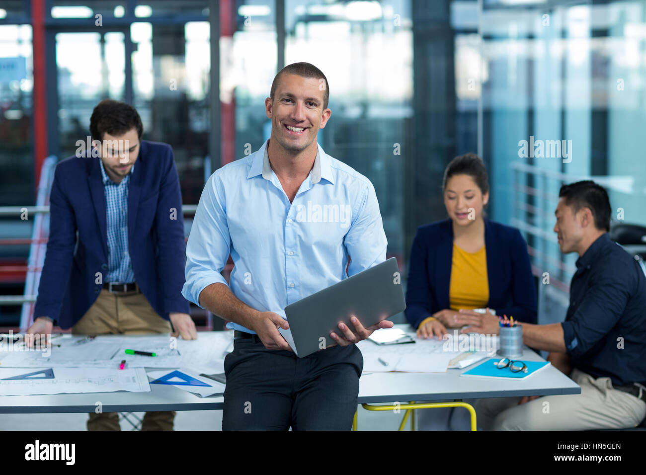 Leaning professional holding laptop hi-res stock photography and images ...
