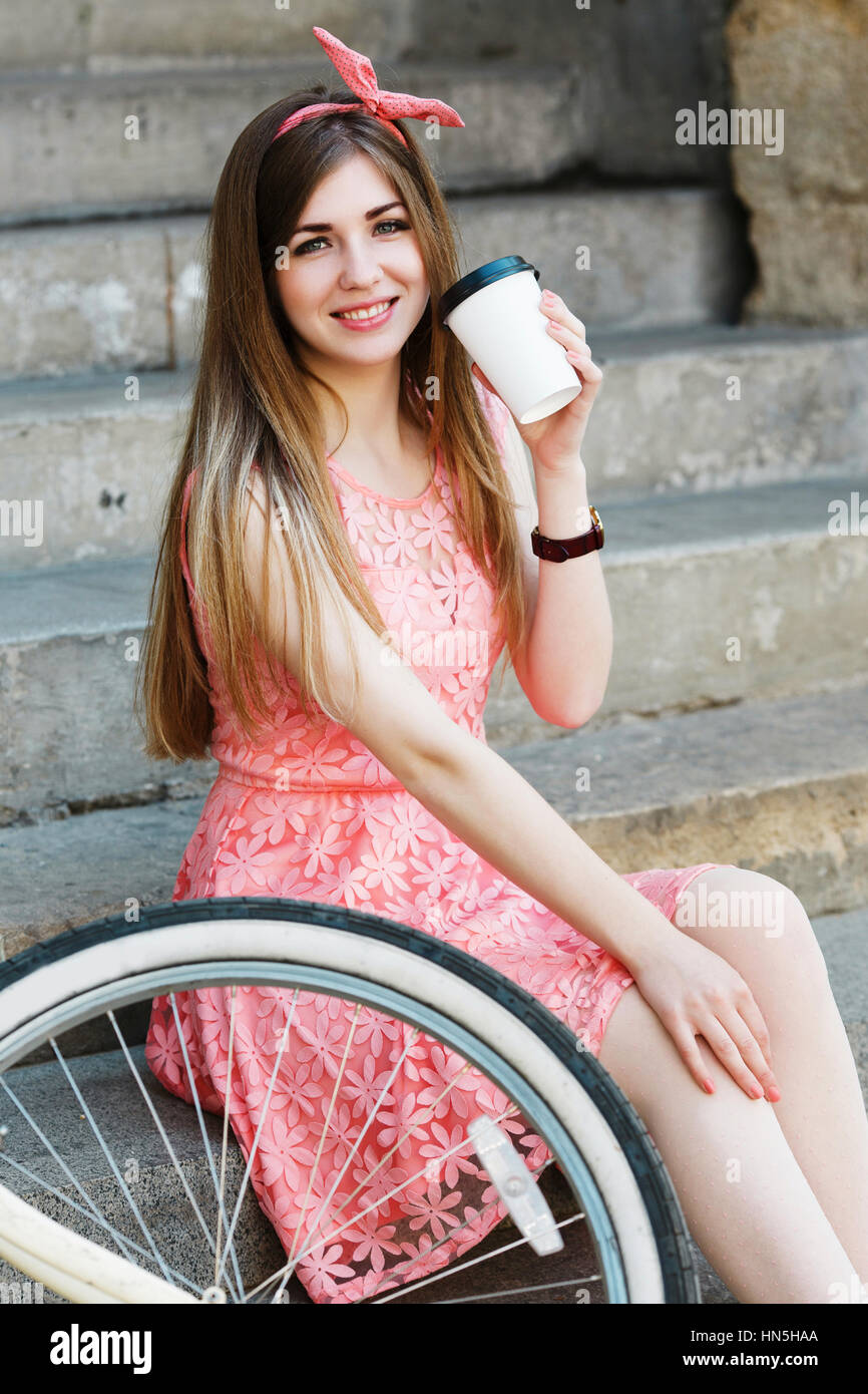 Young girl sitting and looking at camera Stock Photo - Alamy