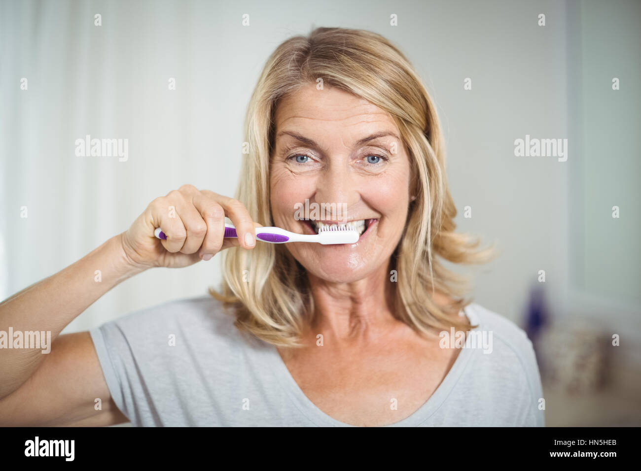 Elderly woman cleaning teeth hires stock photography and images Alamy