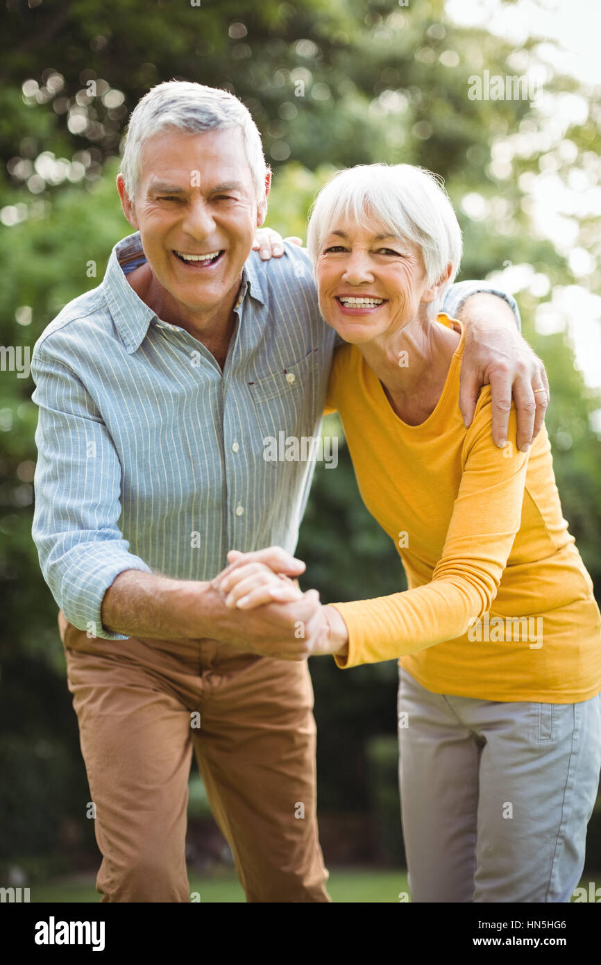 Portrait of happy senior couple dancing in park Stock Photo - Alamy
