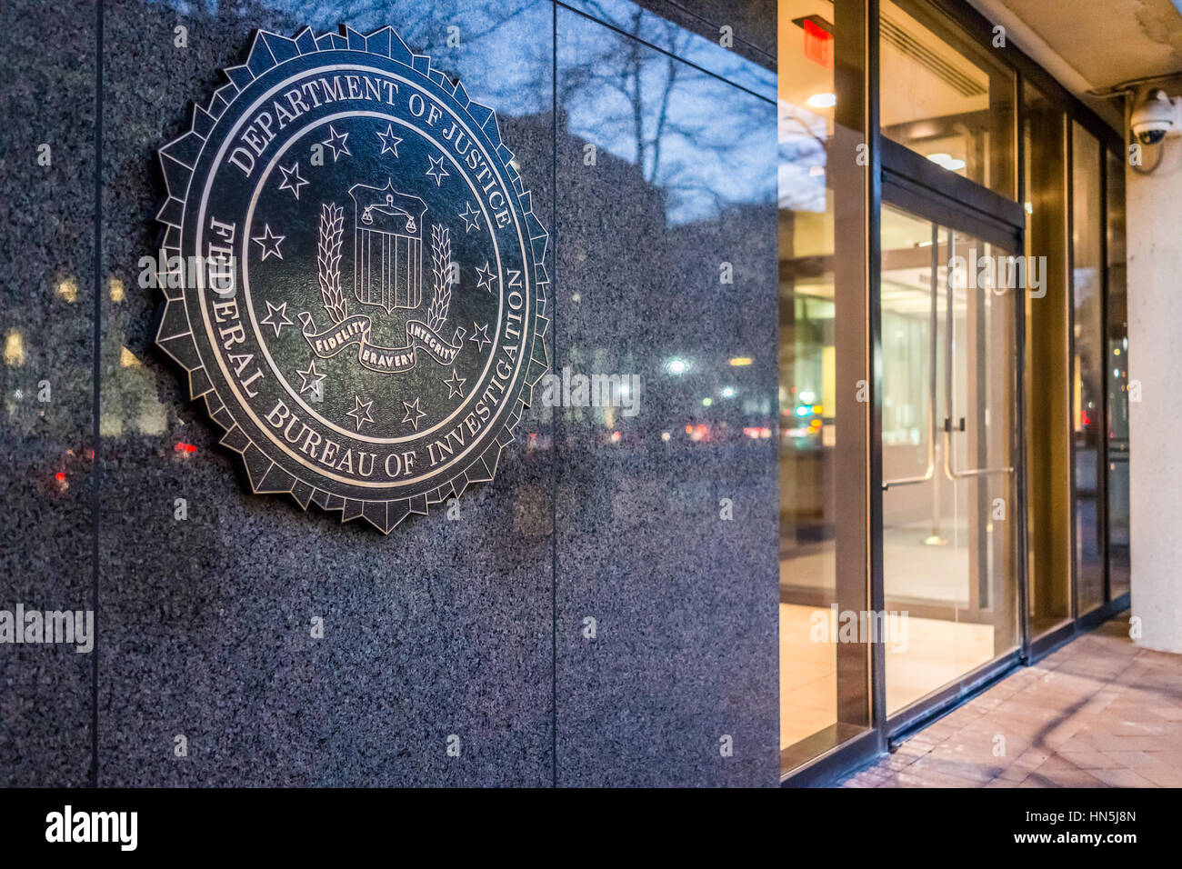 Washington DC, USA - December 29, 2016: FBI, Federal Bureau of Investigation Headquarters, on Pennsylvania avenue sign with traffic reflections at nig Stock Photo