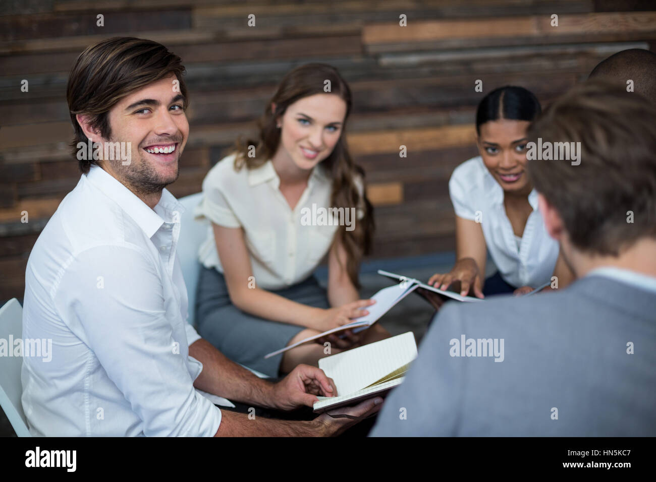 Portrait of business executives working in office Stock Photo - Alamy