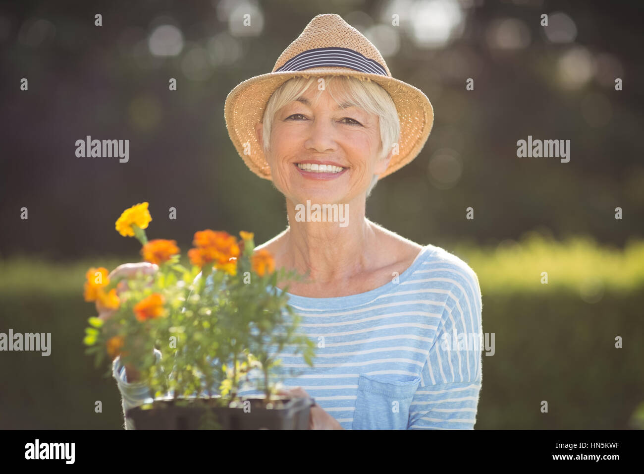 Portrait of happy senior woman gardening in backyard Stock Photo - Alamy