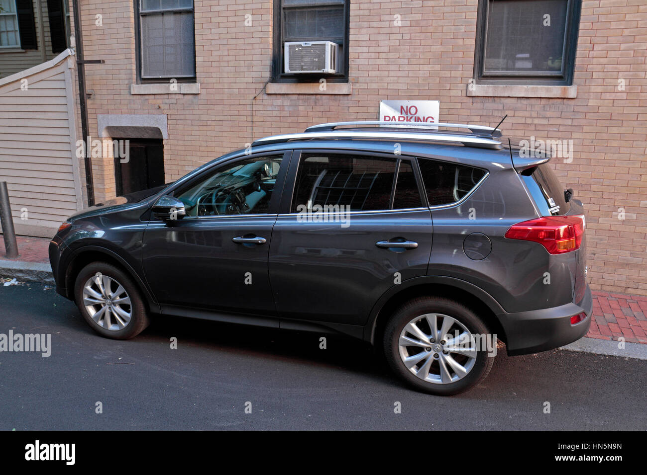 Car parked in front of a "No Parking" sign in the Beacon Hill area of Boston, Massachusetts