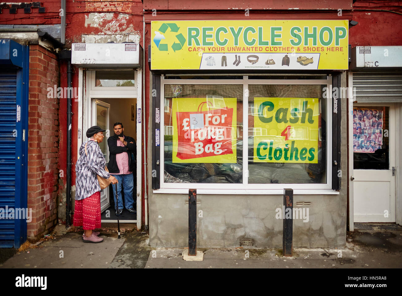 Recycle shop, cash for clothes independent retail shop in the main a6 corridor in Levenshulme, Manchester, England, UK. Stock Photo