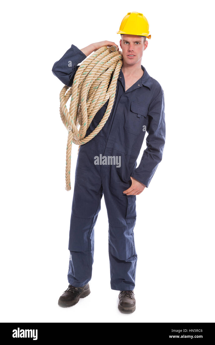 Worker in coverall and yellow helmet with large thick rope isolated on white background Stock Photo
