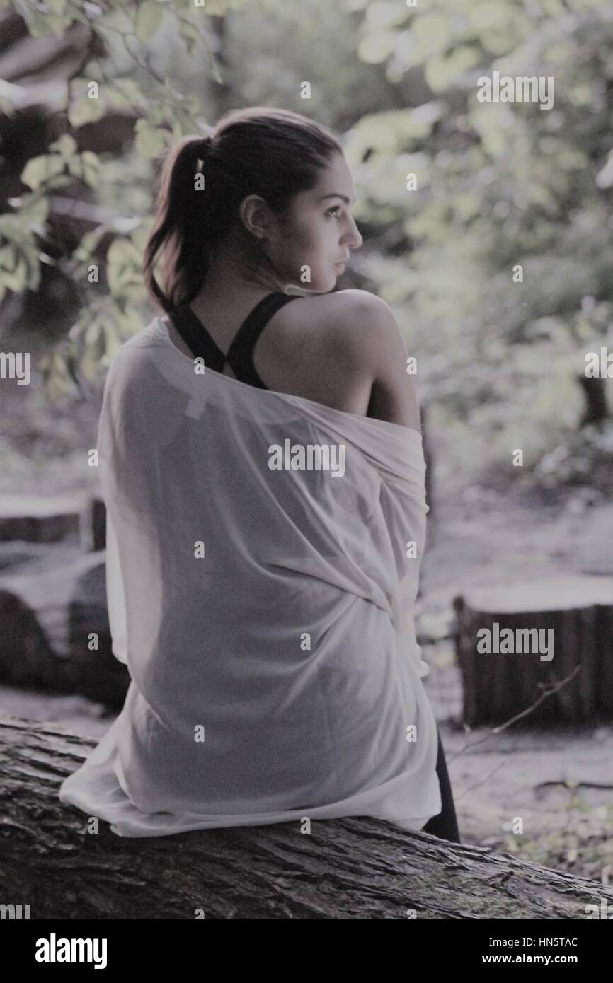 Young woman resting after a workout in the woods Stock Photo - Alamy