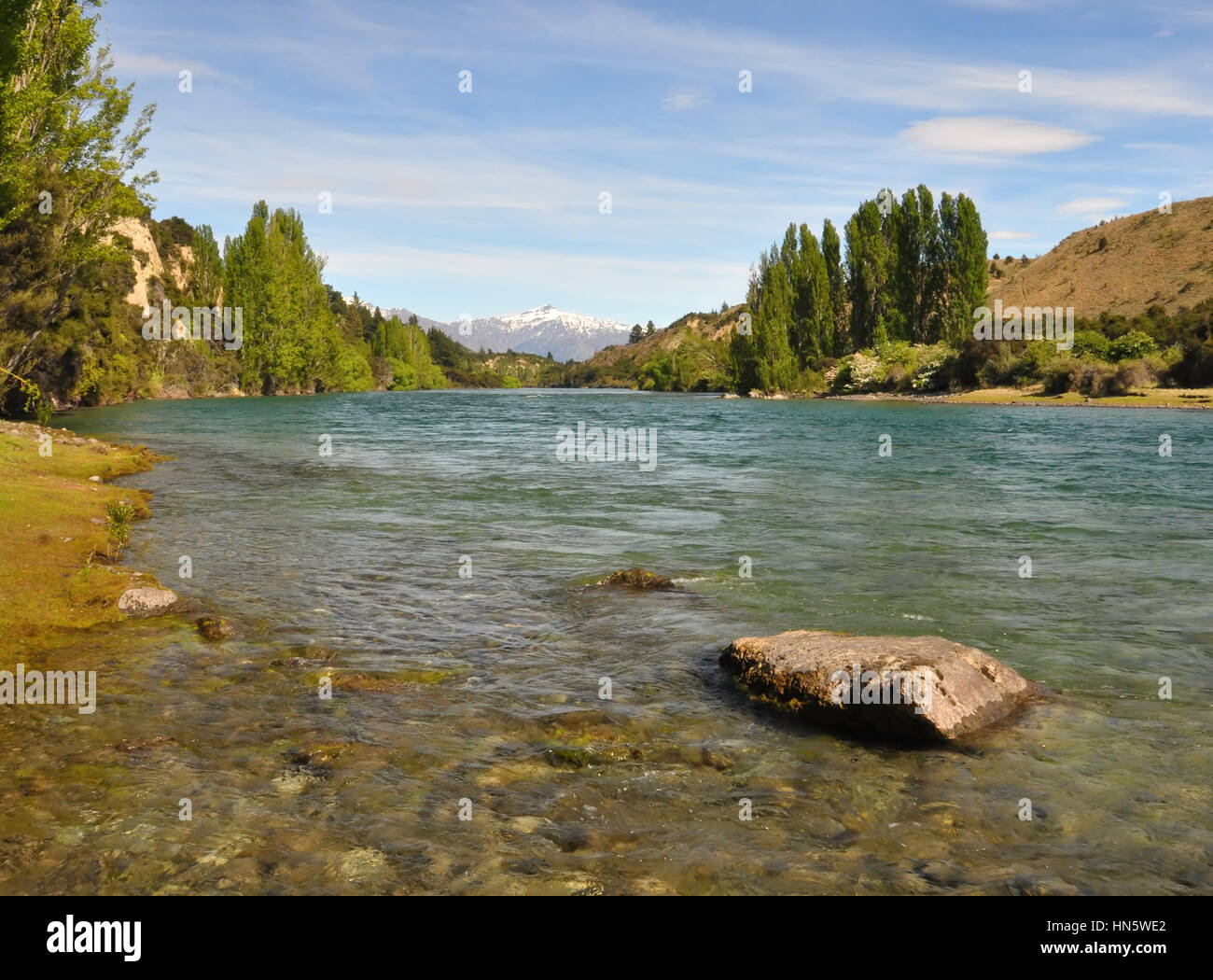 The crystal clear waters of the Clutha river in Otago, New Zealand, One of New Zealand's longest and most beautiful rivers and popular for trout fishi Stock Photo