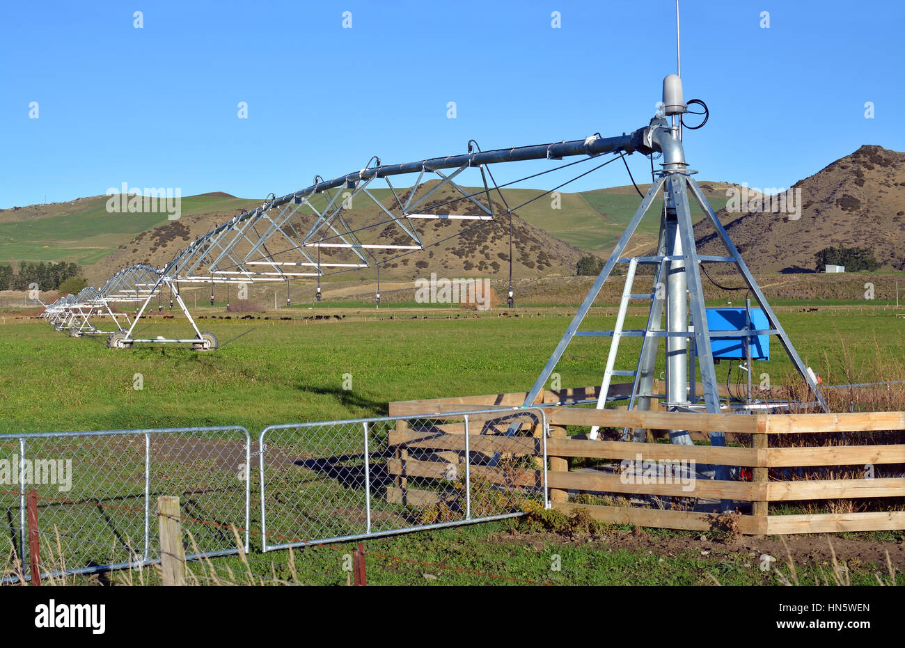 A pivot Irrigation Machine on a farm in North Canterbury, New Zealand ensures that fields are green and productive all year round. Stock Photo