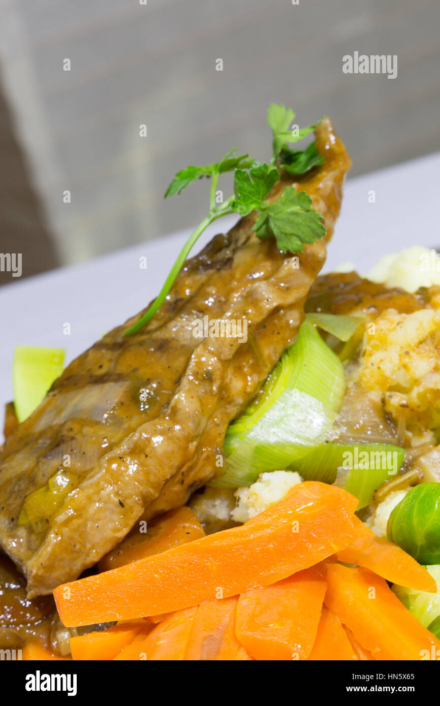 A close up view of a dish of Braised Sirloin Steak served with Creamed