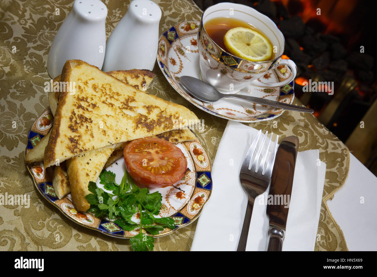 An English breakfast dish of Gypsy Toast served with grilled Tomato