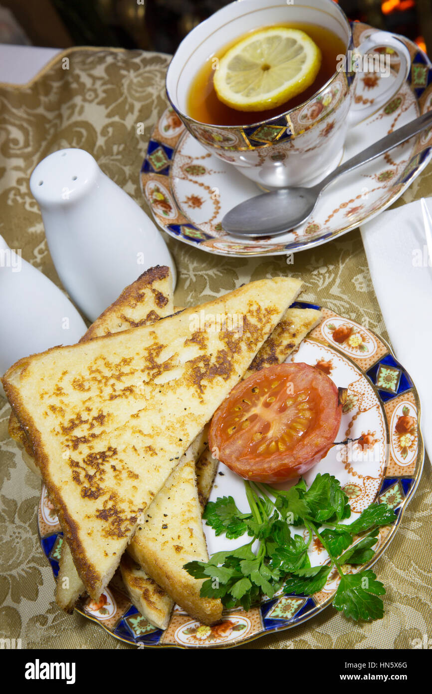 An English breakfast dish of Gypsy Toast served with grilled Tomato