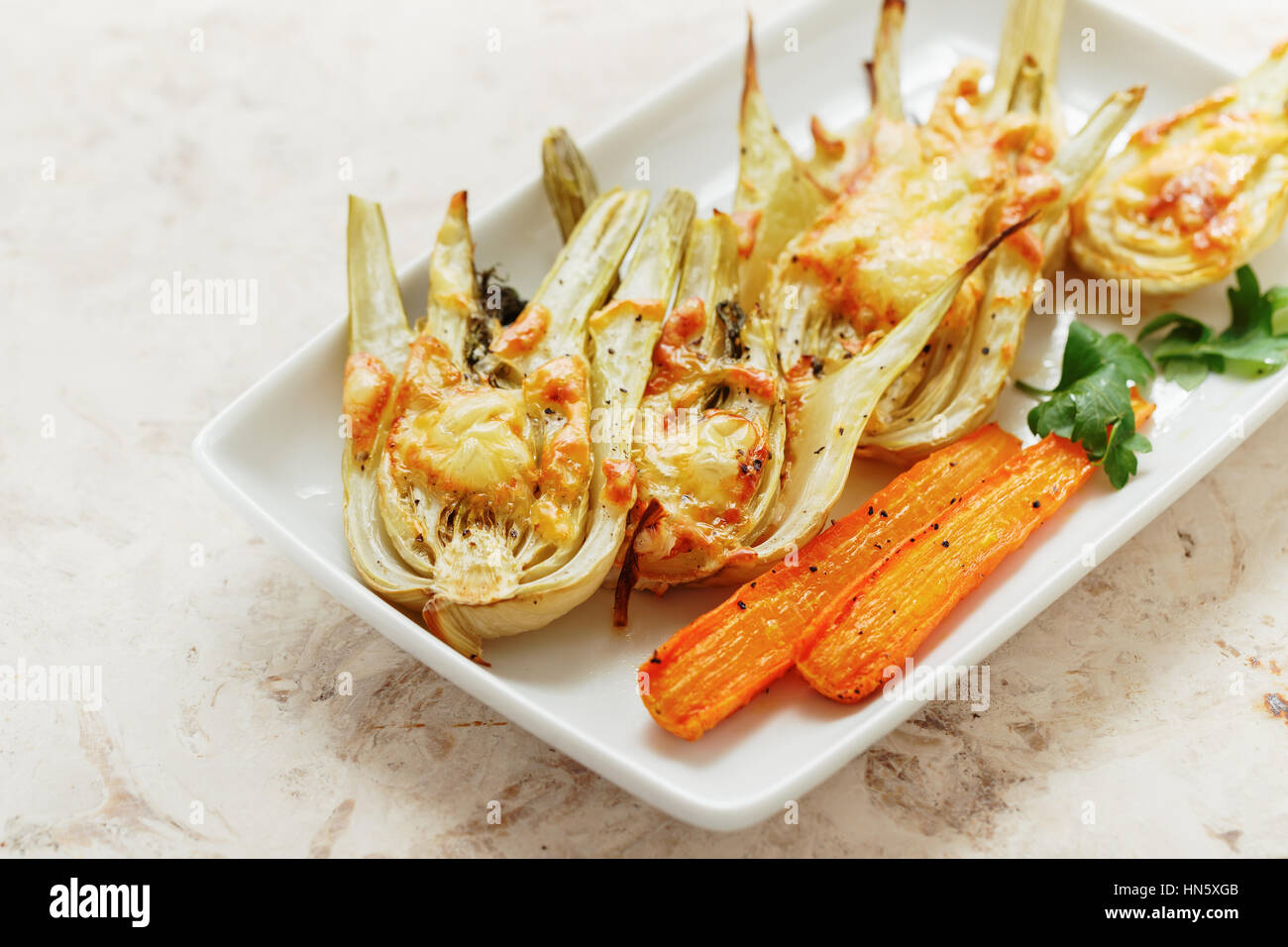 Roasted Fennel with Cheese. Sliced fennel oven roasted in olive oil. Stock Photo