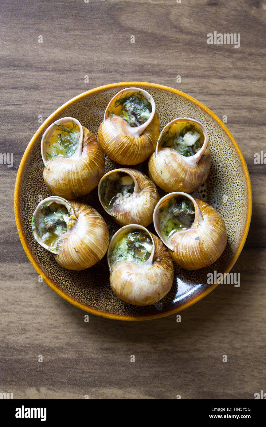 Eating the fried snails in garlic butter, background Stock Photo Alamy