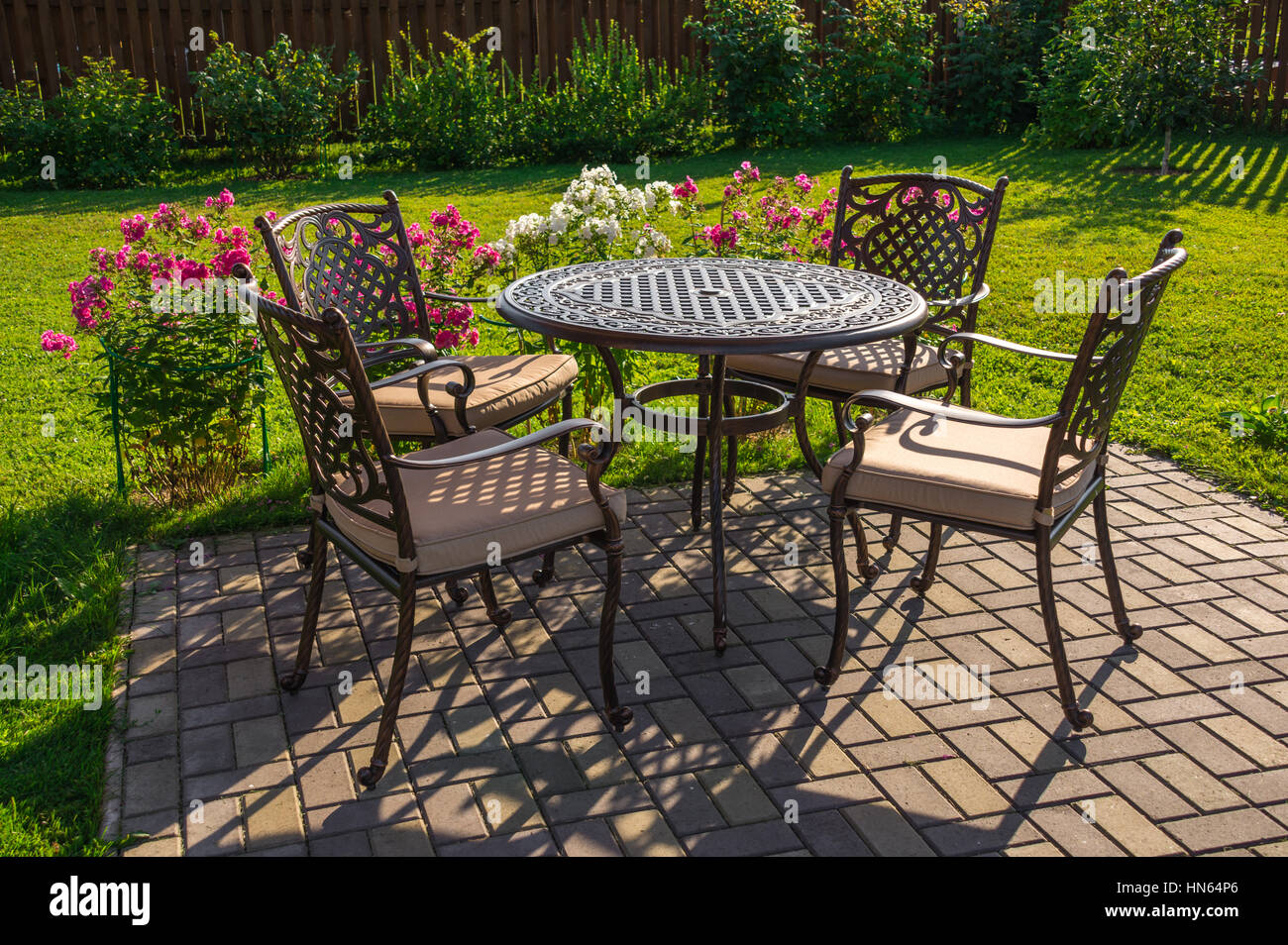 Table and chairs in garden of country house Stock Photo - Alamy