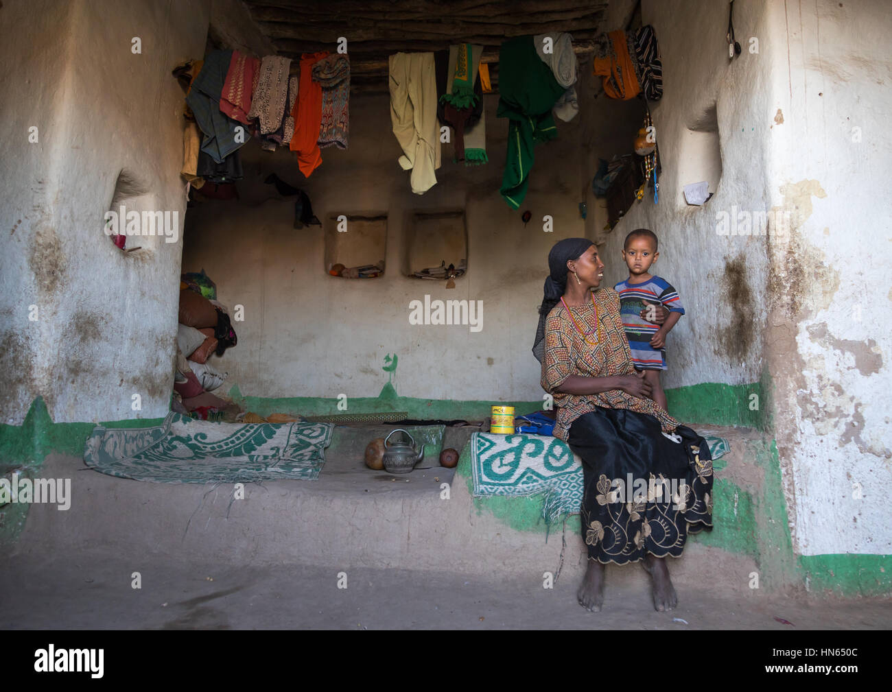 Mother and child inside their traditional Argoba stone house, Harari Region, Koremi, Ethiopia Stock Photo