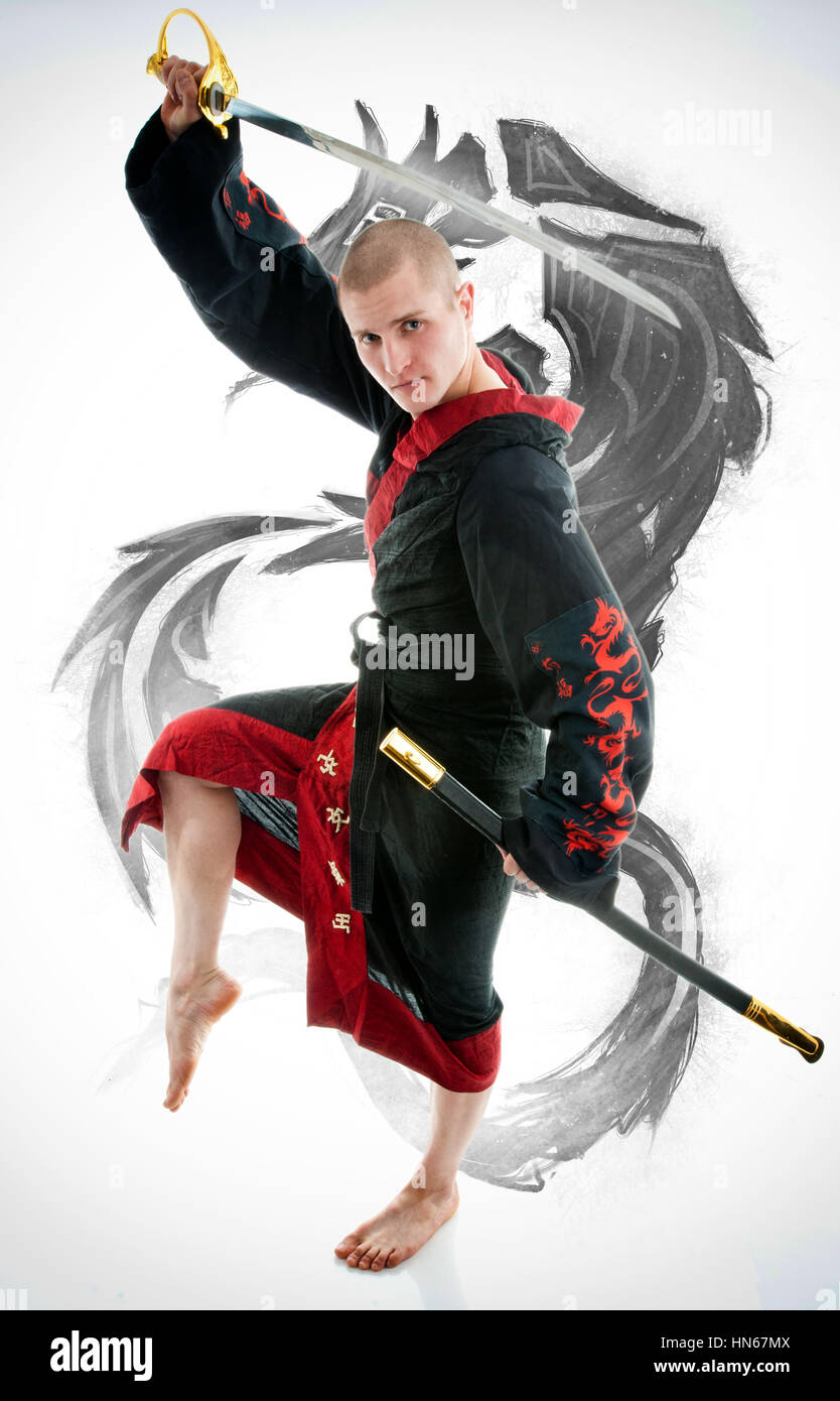 Man dressed in black dragon kimono demonstrating martial arts co Stock Photo