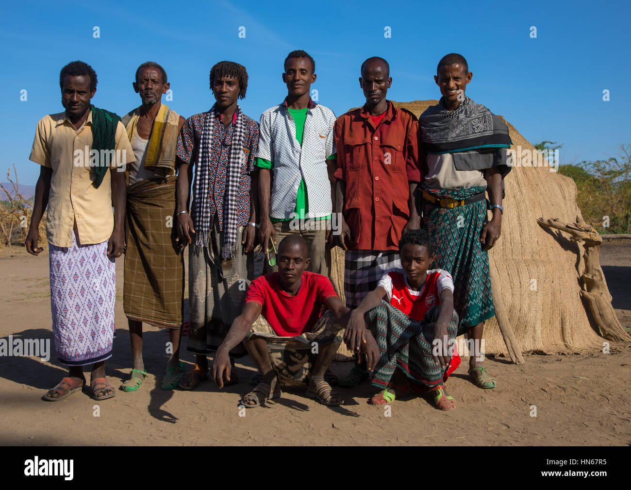 Portrait of Afar tribe men in front of their traditional hut, Afar region, Afambo, Ethiopia Stock Photo