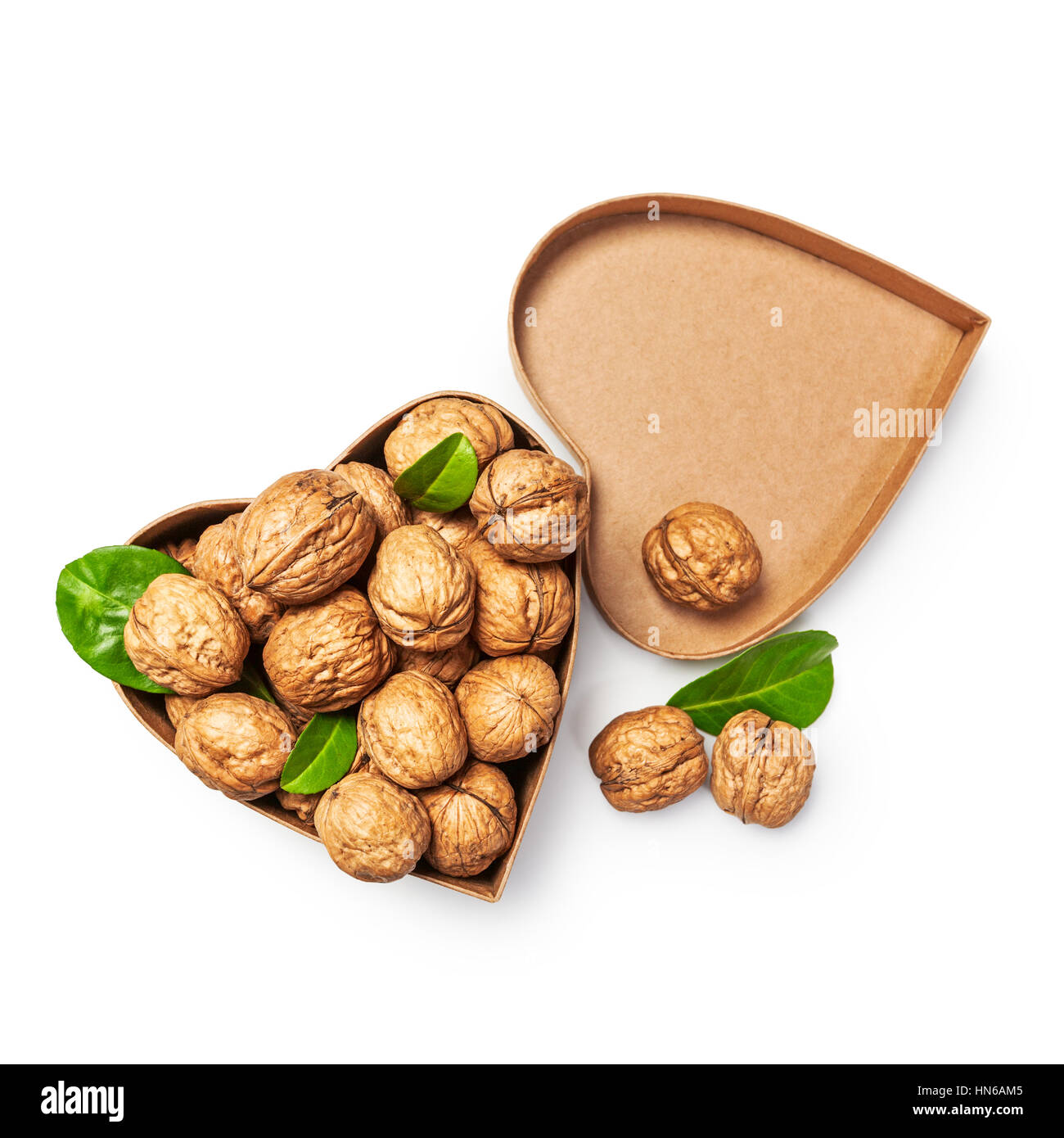 Walnuts in heart shaped box as healthy eating and dieting concept, objects group isolated on white background with clipping path, top view, flat lay Stock Photo