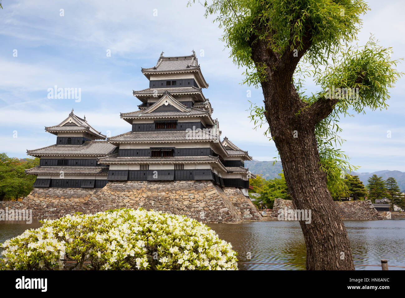 Matsumoto, Japan - May 13, 2012: The keep and moat of Matsumoto castle in Nagano Prefecture, viewed from the surrounding park. The castle is designate Stock Photo