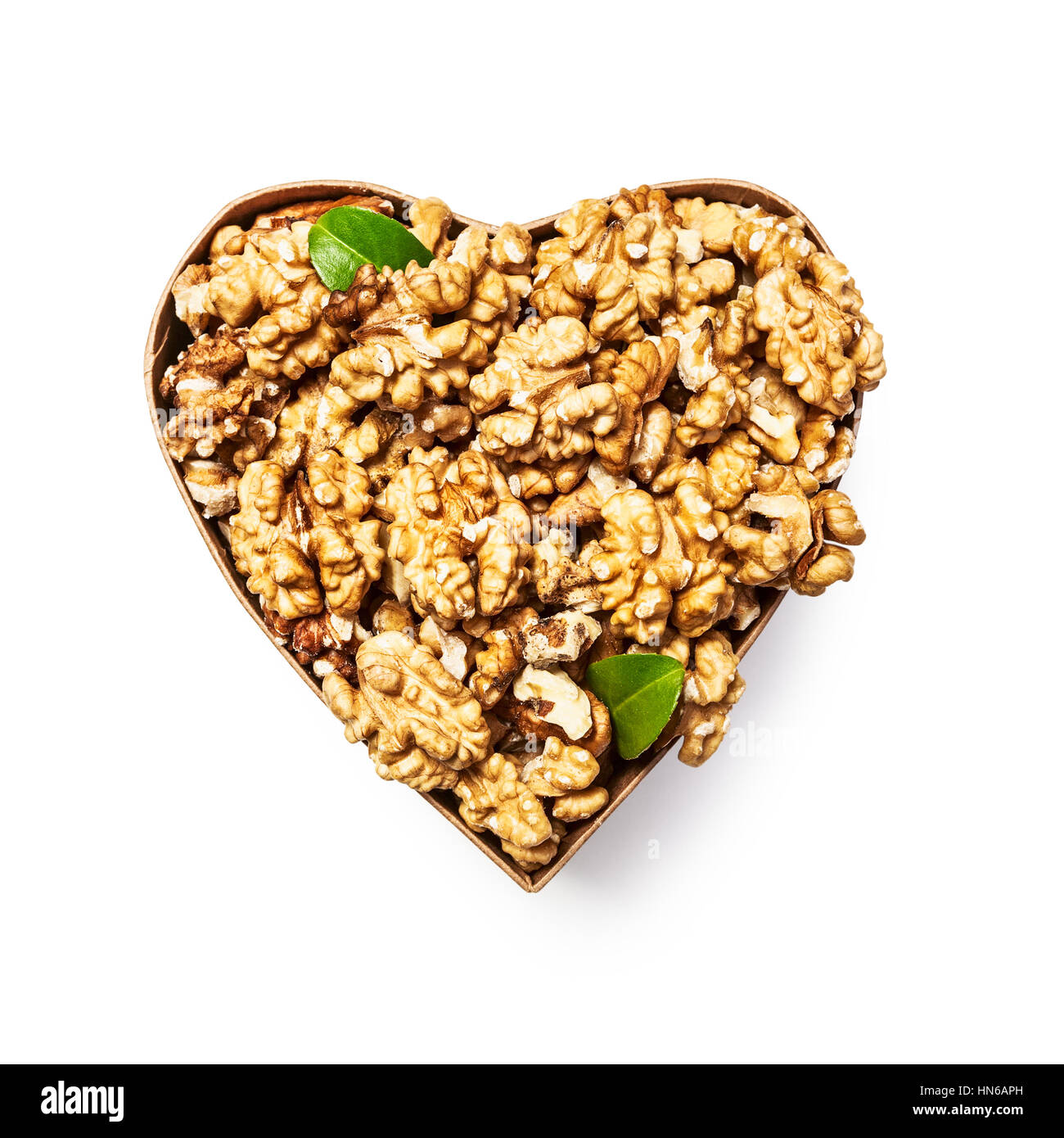 Walnut kernels in heart shaped box as healthy eating and alternative medicine concept, single object isolated on white background with clipping path,  Stock Photo